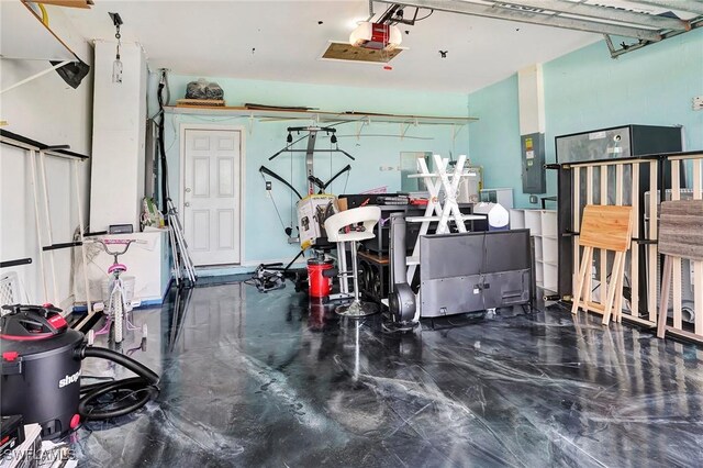 garage featuring electric panel and a garage door opener