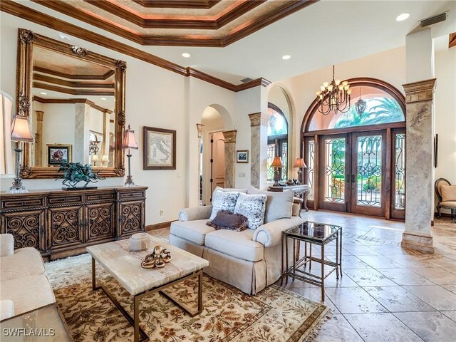 living room featuring french doors, ornamental molding, a high ceiling, and a tray ceiling