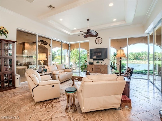 living room with crown molding, a raised ceiling, and ceiling fan