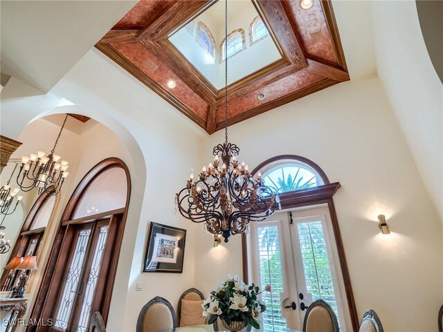 room details featuring an inviting chandelier and french doors