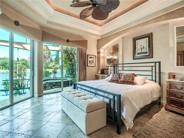 bedroom with a tray ceiling, access to outside, and ornamental molding