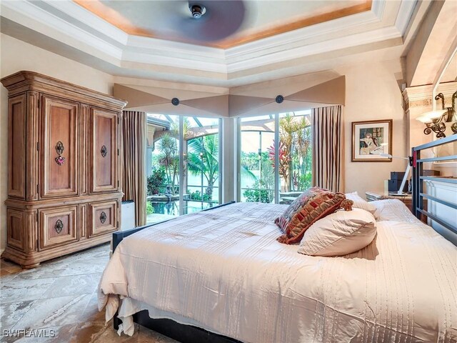 bedroom featuring a raised ceiling and ornamental molding