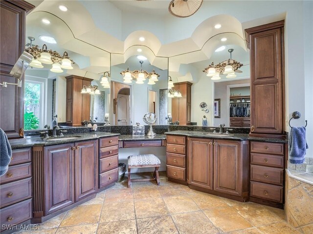 bathroom featuring vanity and a chandelier