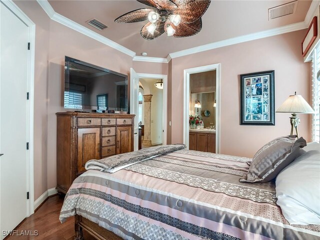 bedroom featuring hardwood / wood-style flooring, ceiling fan, ensuite bathroom, and crown molding