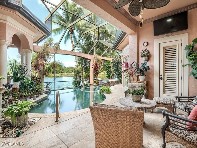 view of swimming pool featuring an in ground hot tub, a lanai, ceiling fan, a water view, and a patio area