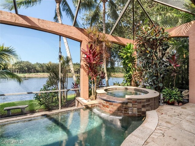 view of pool with an in ground hot tub, a water view, and a patio area