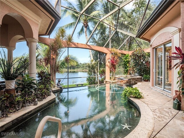 view of swimming pool with an in ground hot tub, a water view, a patio area, and a lanai