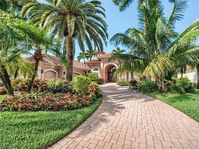 mediterranean / spanish home featuring a garage