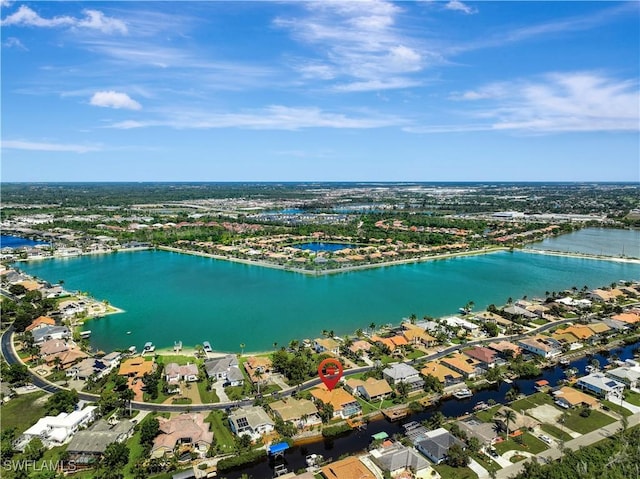 birds eye view of property featuring a water view and a residential view