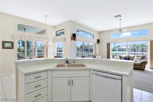 kitchen featuring visible vents, dishwasher, open floor plan, white cabinetry, and a sink