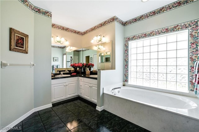 bathroom with double vanity, a sink, baseboards, and a bath