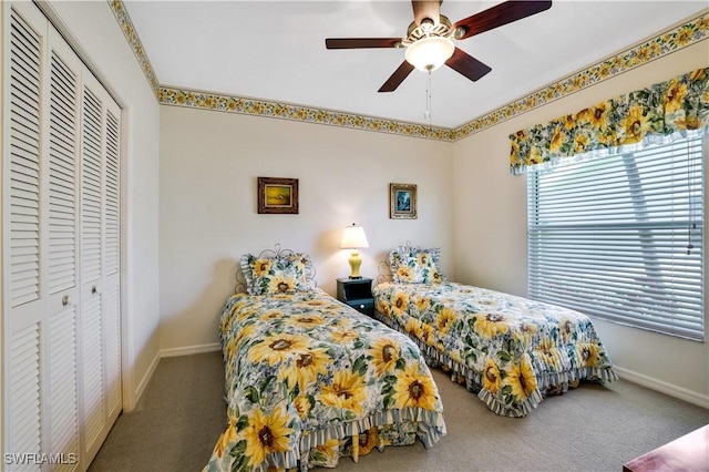 carpeted bedroom with a closet, a ceiling fan, and baseboards