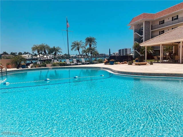 222 Harbour Dr Unit 114, Naples, FL 34103 - community pool featuring a patio