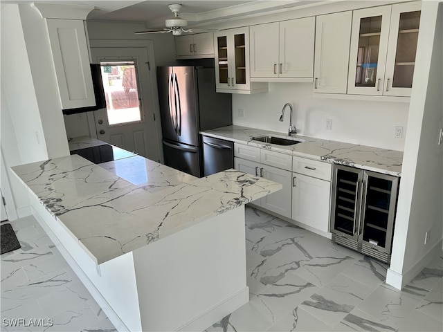 222 Harbour Dr Unit 114, Naples, FL 34103 - kitchen featuring light stone countertops, wine cooler, white cabinetry, and sink