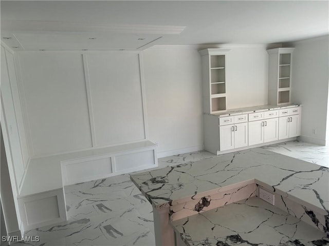222 Harbour Dr Unit 114, Naples, FL 34103 - unfurnished dining area with light marble finish floors and baseboards