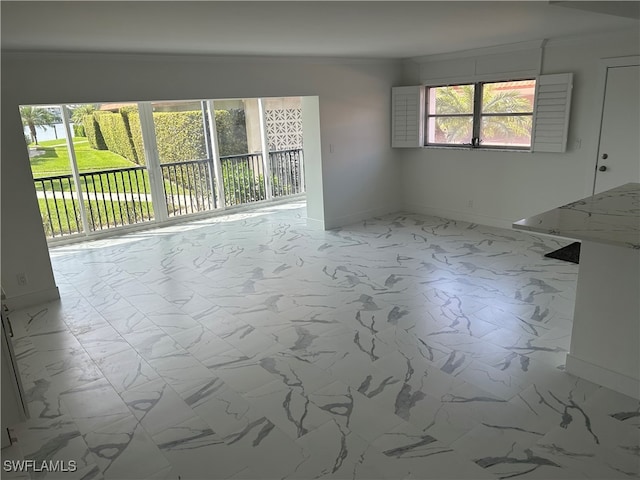 222 Harbour Dr Unit 114, Naples, FL 34103 - empty room featuring plenty of natural light and ornamental molding