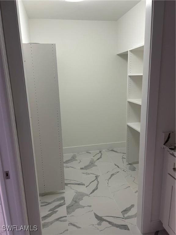 222 Harbour Dr Unit 114, Naples, FL 34103 - spacious closet featuring marble finish flooring