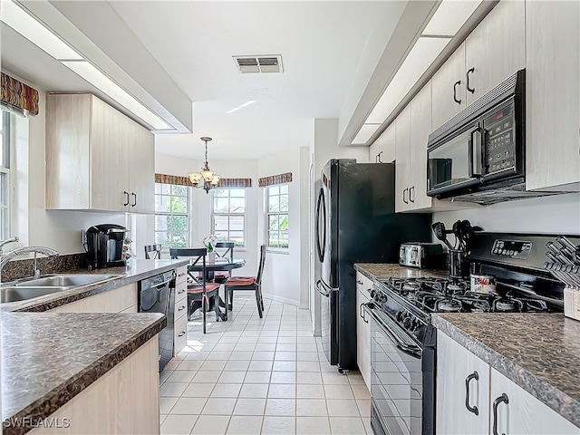 kitchen with pendant lighting, a chandelier, black appliances, sink, and light tile patterned flooring