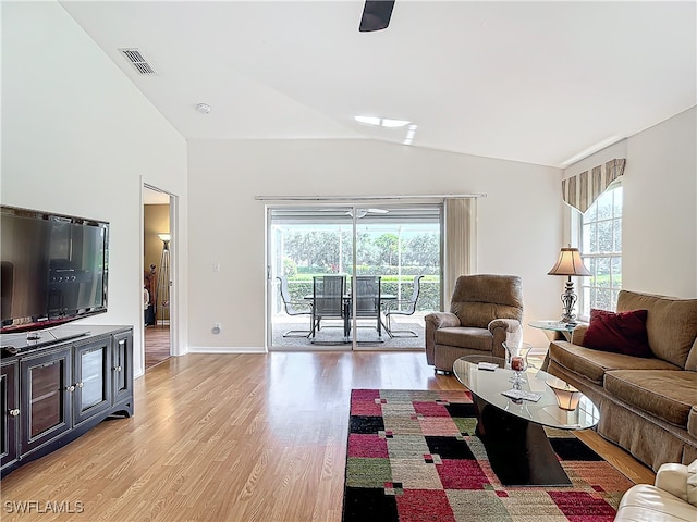 living room with lofted ceiling and light hardwood / wood-style floors