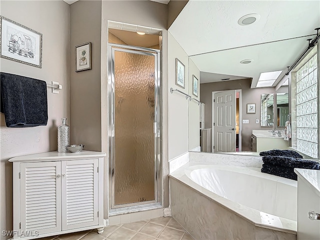 bathroom with tile patterned flooring, vanity, and separate shower and tub