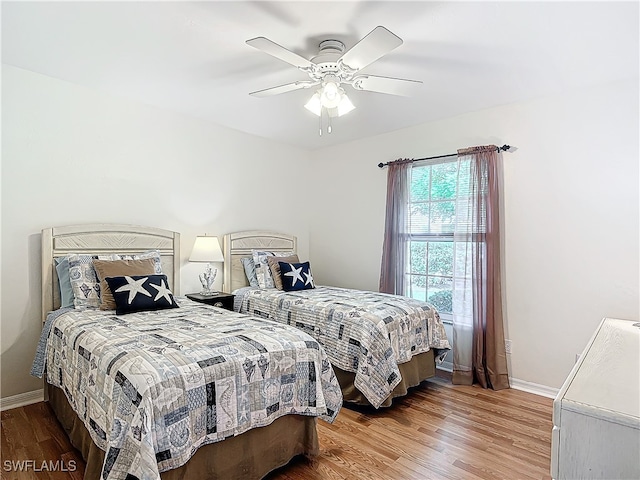 bedroom featuring wood-type flooring and ceiling fan