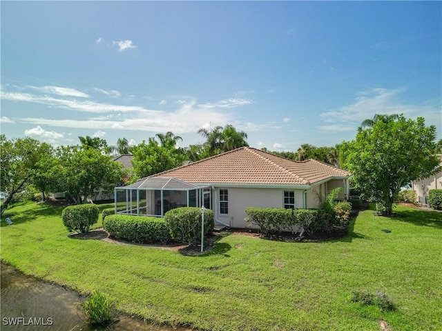 view of home's exterior featuring a lanai, stucco siding, a tile roof, and a yard