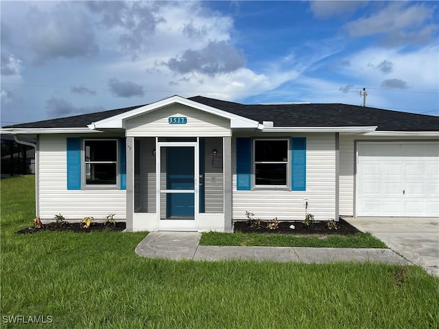 view of front of property with a garage and a front lawn