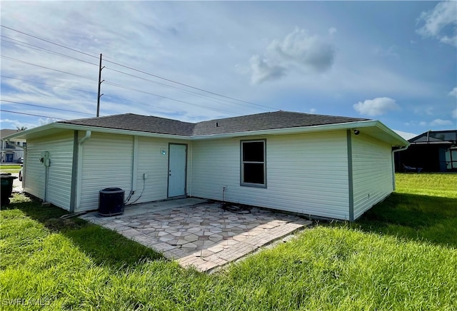 back of house with a yard and a patio area