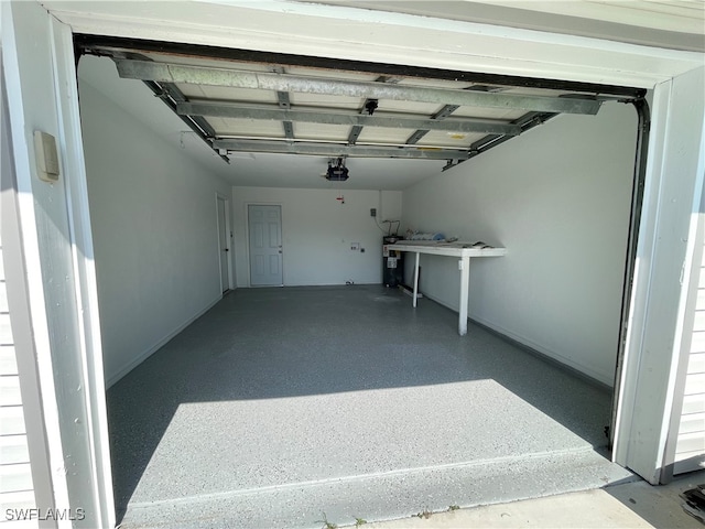 garage with electric water heater and a garage door opener