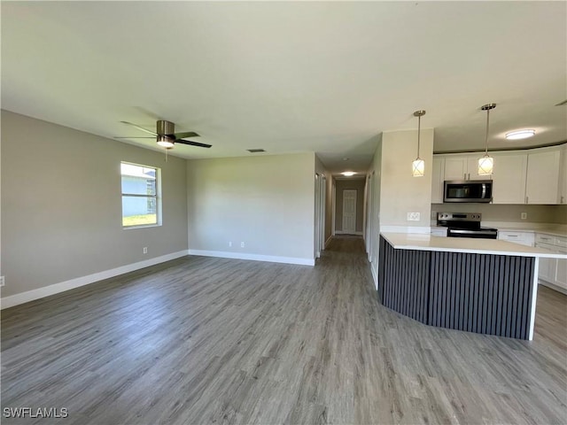 kitchen with ceiling fan, light wood-type flooring, decorative light fixtures, white cabinetry, and stainless steel appliances