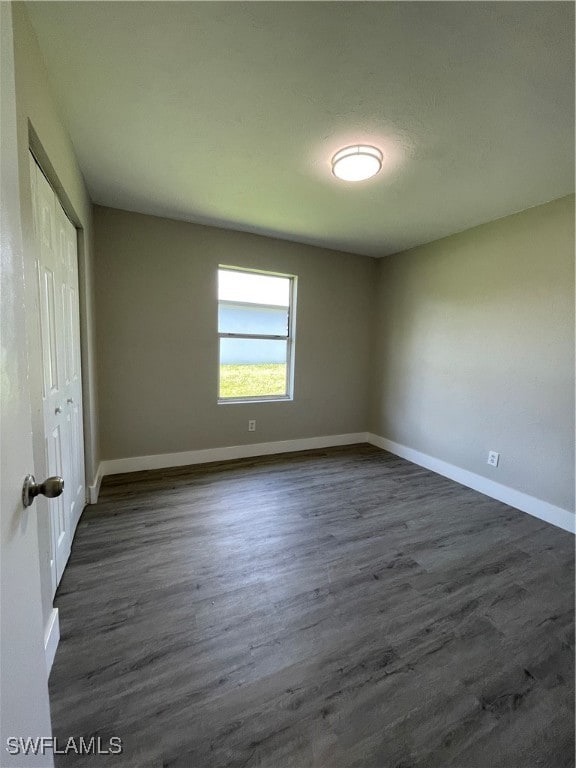 empty room featuring dark hardwood / wood-style flooring