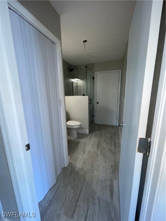 bathroom with toilet and walk in shower