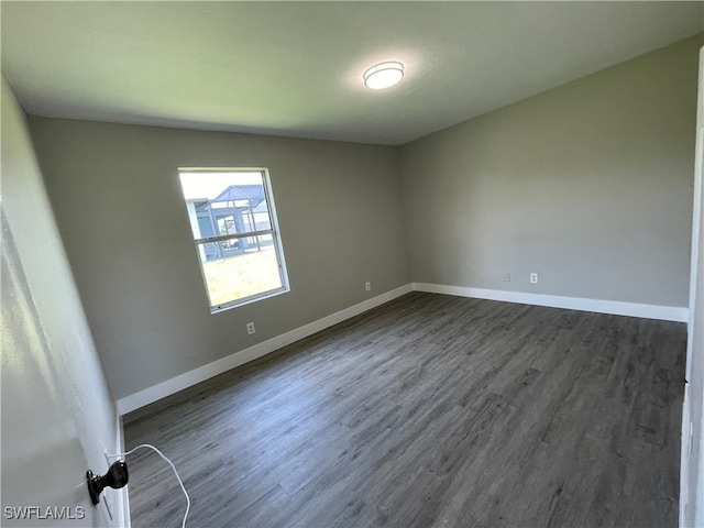 spare room featuring dark wood-type flooring