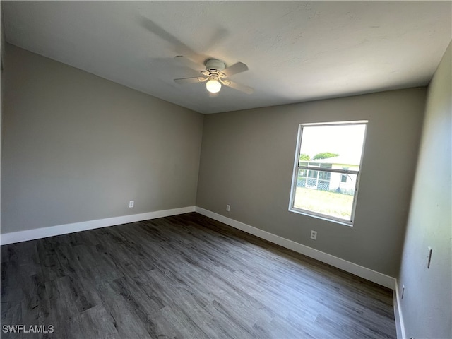 empty room featuring ceiling fan and dark hardwood / wood-style floors