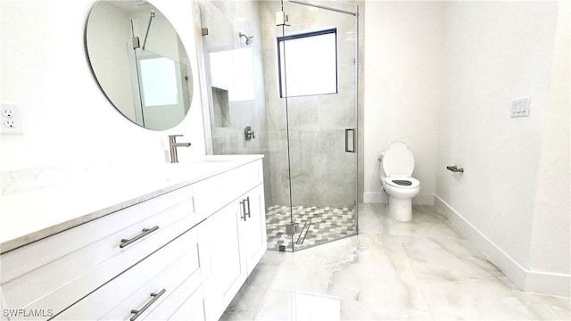 bathroom featuring toilet, vanity, and a shower with shower door