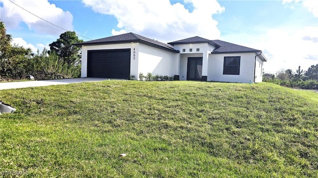 view of front of house with a garage and a front yard