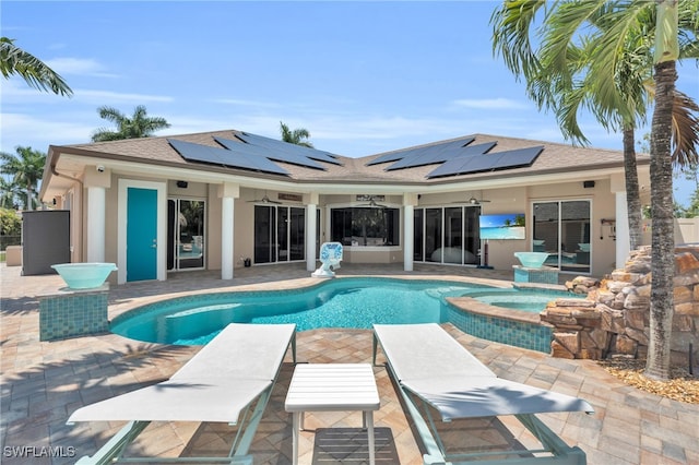 view of swimming pool featuring an in ground hot tub and a patio