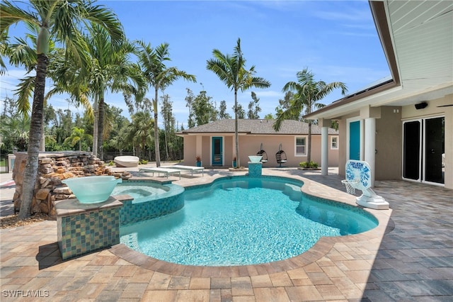 view of pool featuring an in ground hot tub and a patio