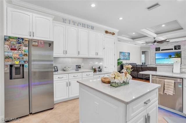 kitchen featuring light countertops, appliances with stainless steel finishes, and white cabinetry