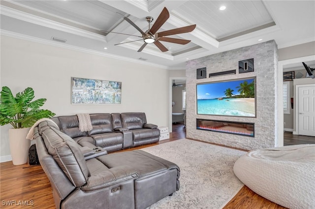 living area featuring crown molding, visible vents, coffered ceiling, and wood finished floors