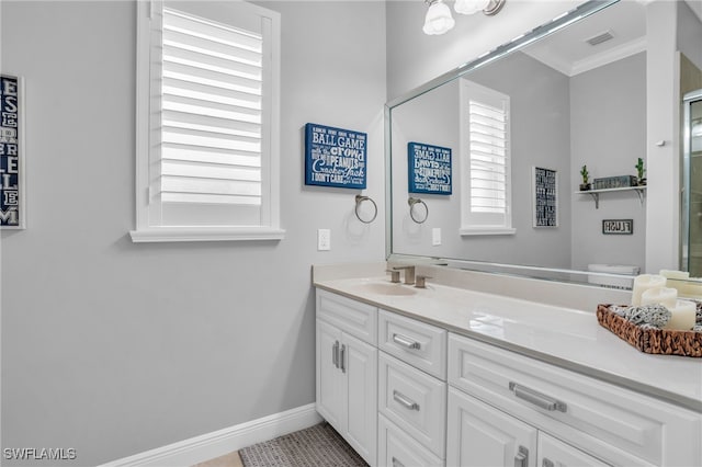 bathroom with crown molding and vanity