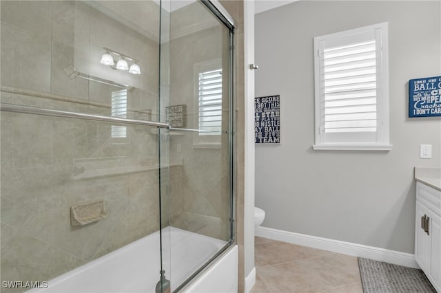 full bathroom featuring tile patterned flooring, vanity, bath / shower combo with glass door, and toilet