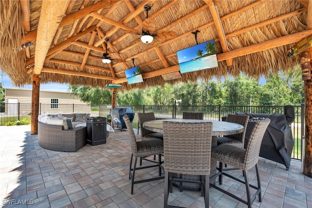 view of patio with ceiling fan, outdoor lounge area, a gazebo, and area for grilling