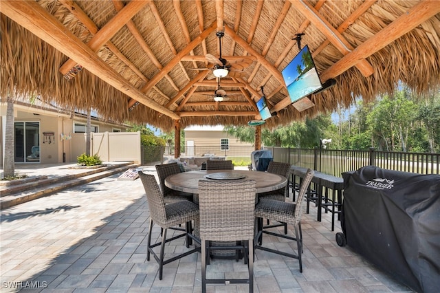 view of patio / terrace with a gazebo, ceiling fan, and grilling area