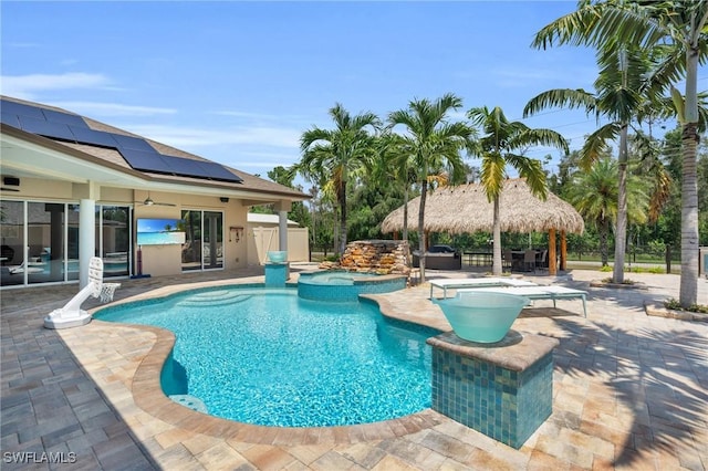 view of swimming pool featuring a patio area, a pool with connected hot tub, and a gazebo