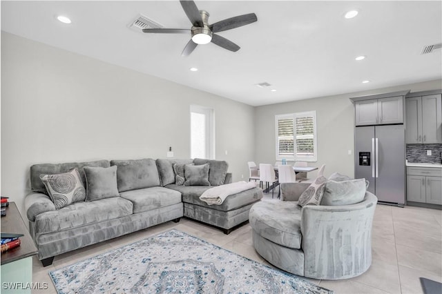 living area featuring recessed lighting, visible vents, and light tile patterned floors