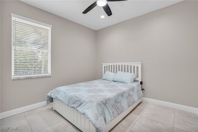 tiled bedroom featuring ceiling fan