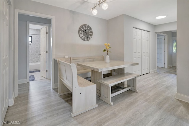 dining room featuring light wood-style floors and baseboards