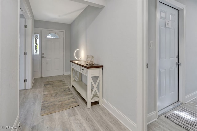 entrance foyer with light wood-type flooring and baseboards