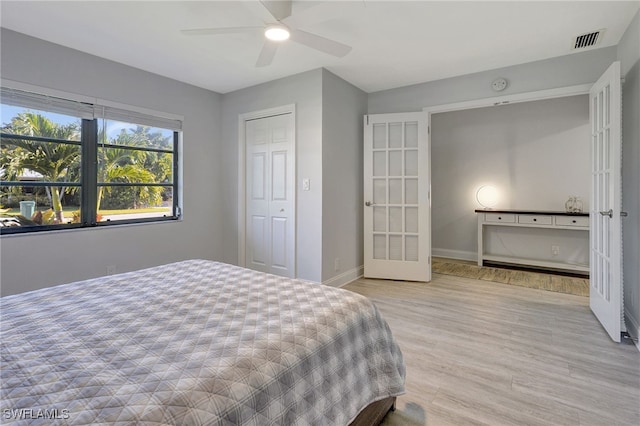 bedroom with ceiling fan, visible vents, baseboards, french doors, and light wood-type flooring